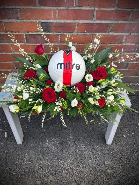 Football in a feild of flowers
